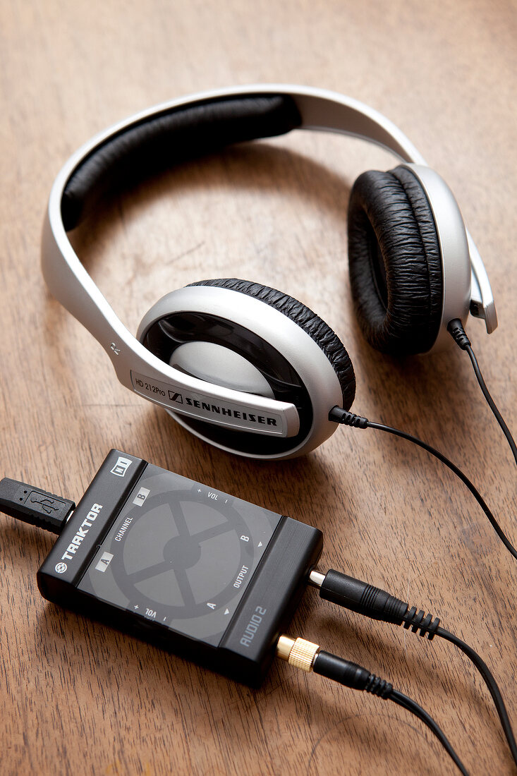 Close-up of headphones and Mp3 player on wooden surface