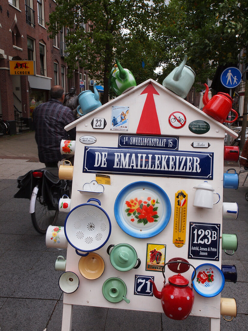 Sign board of De Emaillekeizer with kettles and cups, De Pijp, Amsterdam, Netherlands