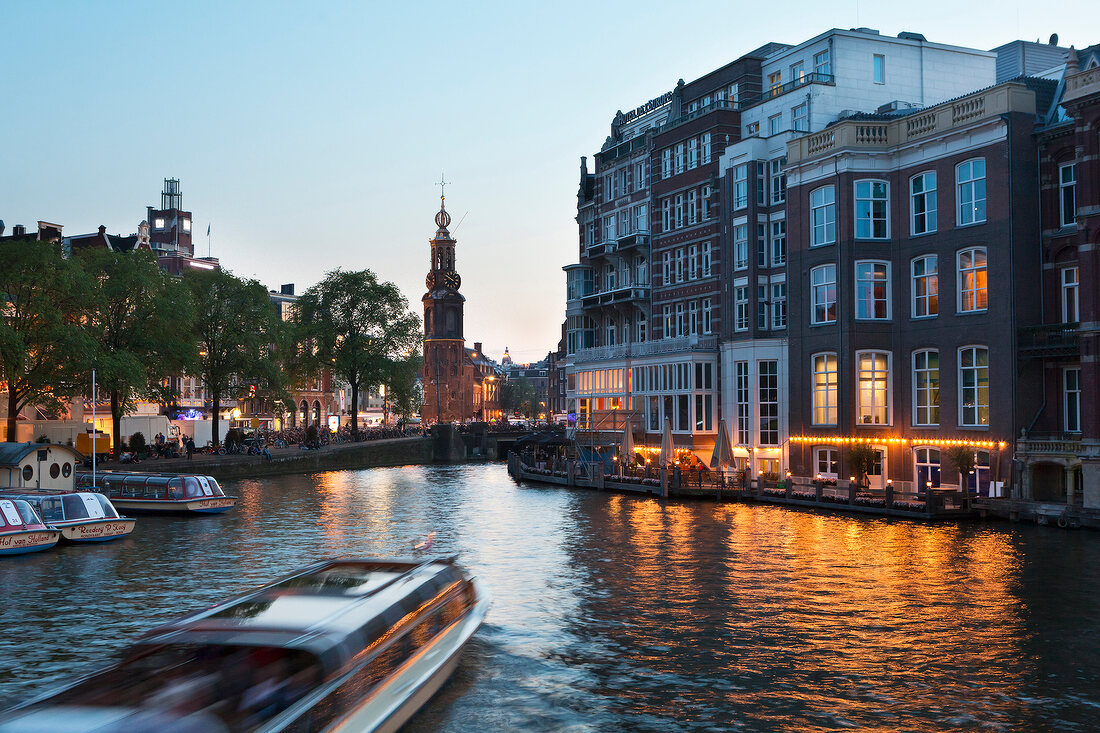 View of Munt Tower and canal houses in Amstel, Amsterdam, Netherlands, blurred motion