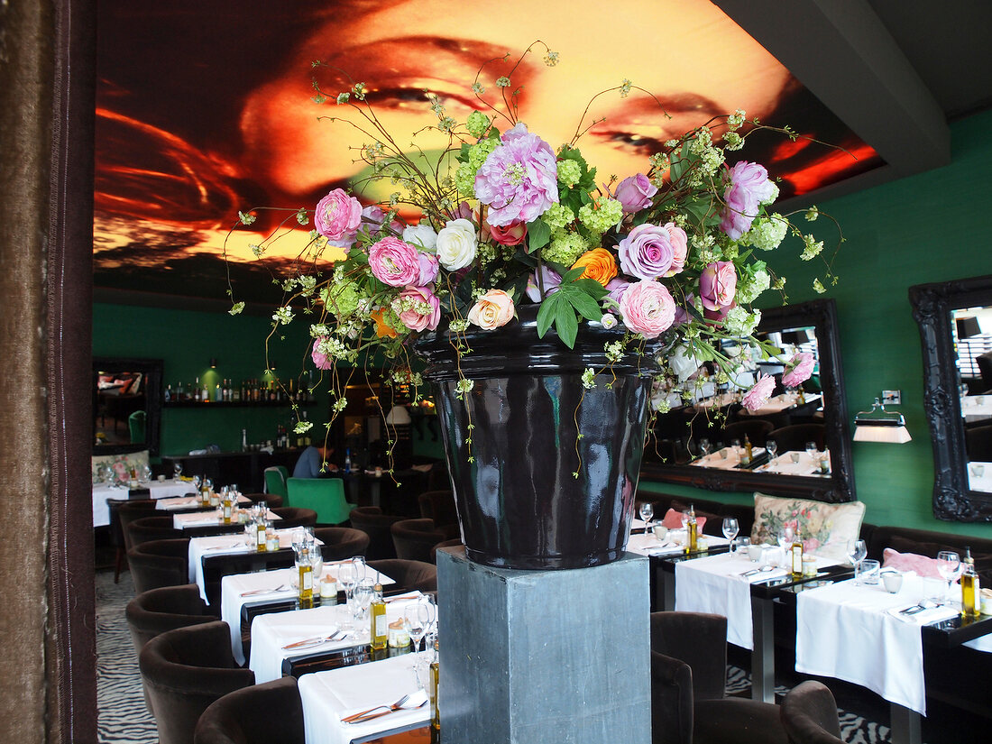 Flowers in pot and laid tables in Restaurant Red, Keizersgracht, Amsterdam, Netherlands