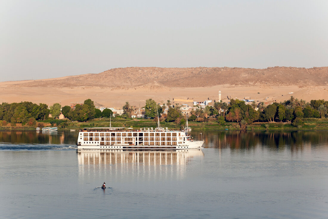 View of Cruise ship on river Nile overlooking mountains, Egypt