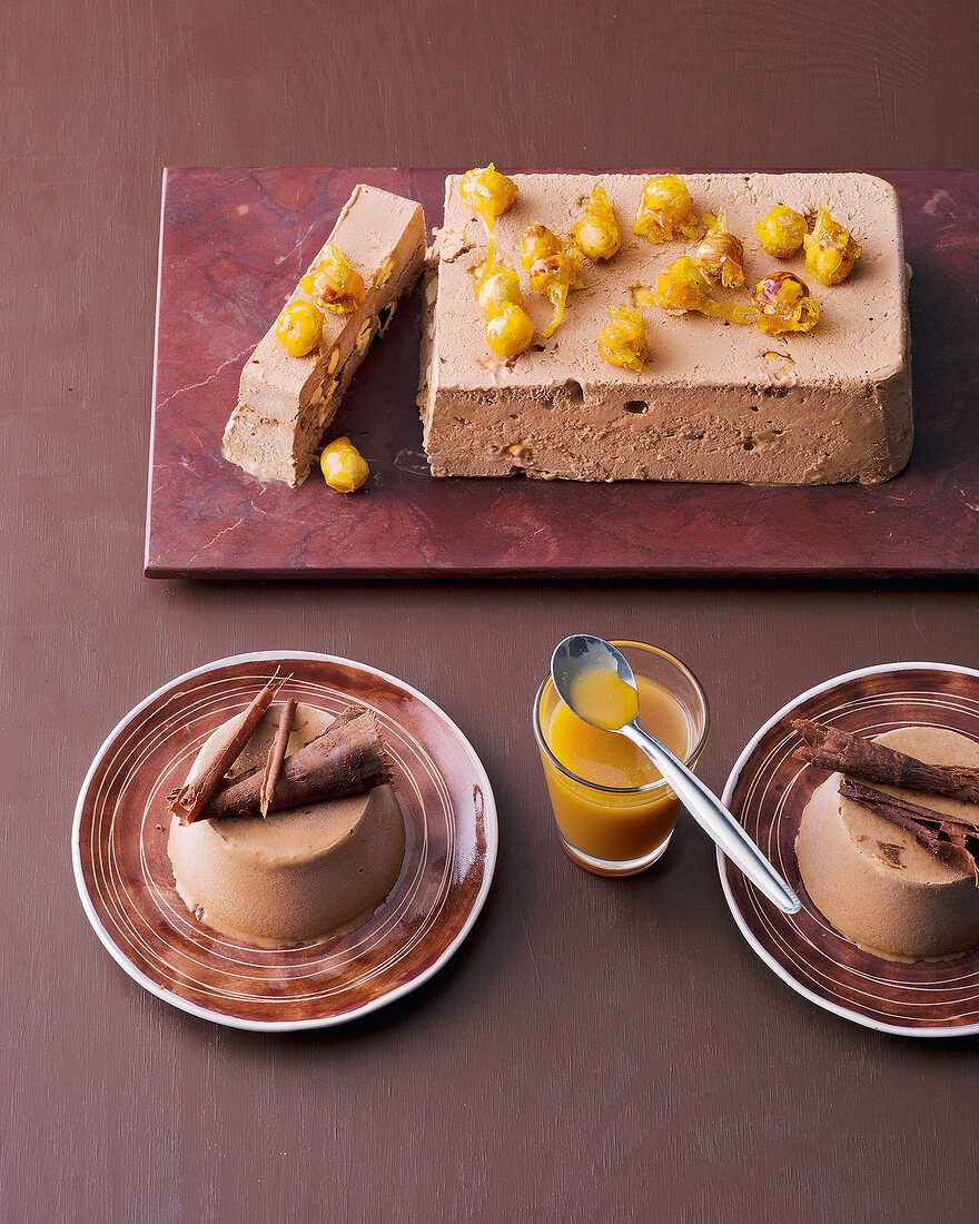 Chocolate nut ice-cream on chopping board and chocolate truffle tart on plates