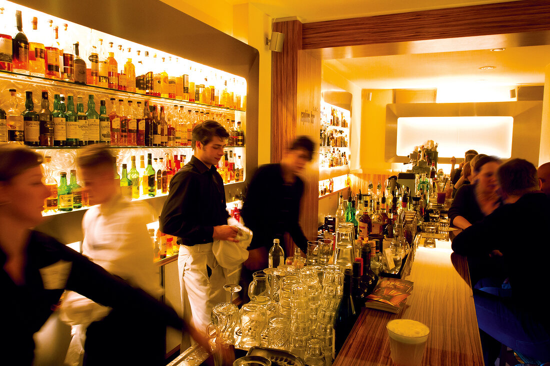 Bartender working at bar counter in Sapphires, Berlin, Germany