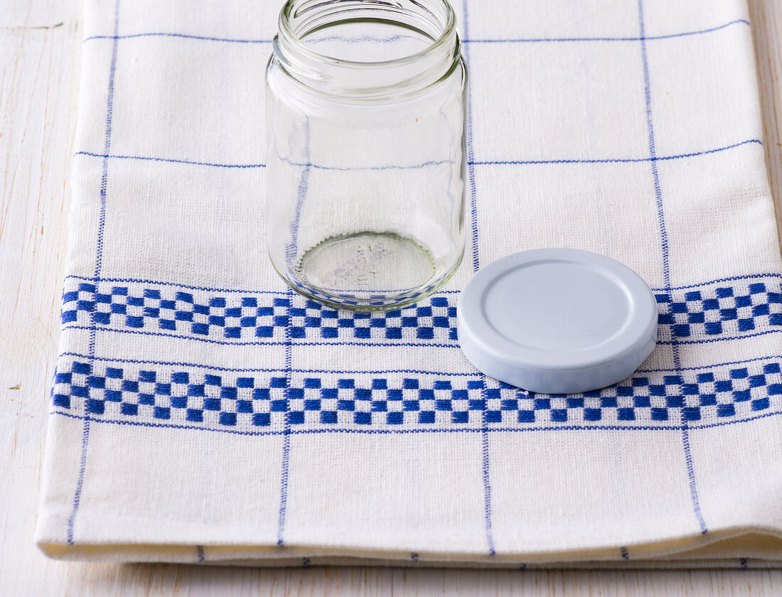 Glass jar with lid on a kitchen napkin