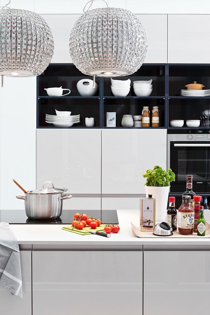 Modern kitchen with island counter and crystal lampshades