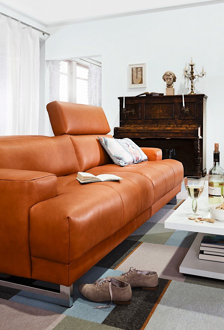 Brown leather sofa and piano in living room