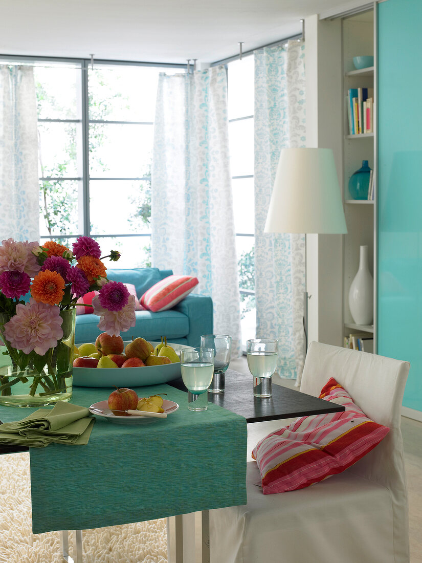 Living room and dining area in blue and turquoise shades