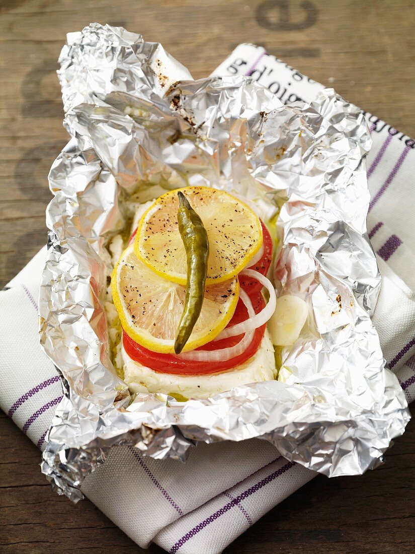 Feta parcel with tomatoes in tin foil