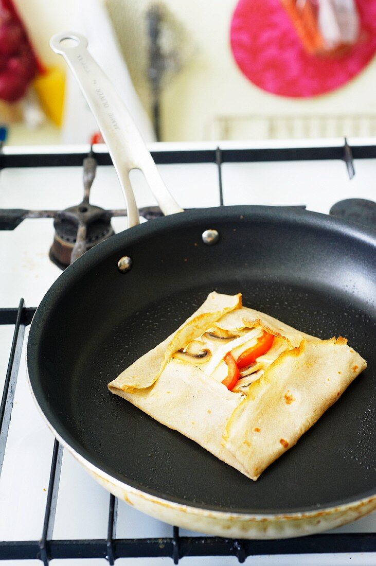 Cooking for students: cheese and vegetable galette in a pan