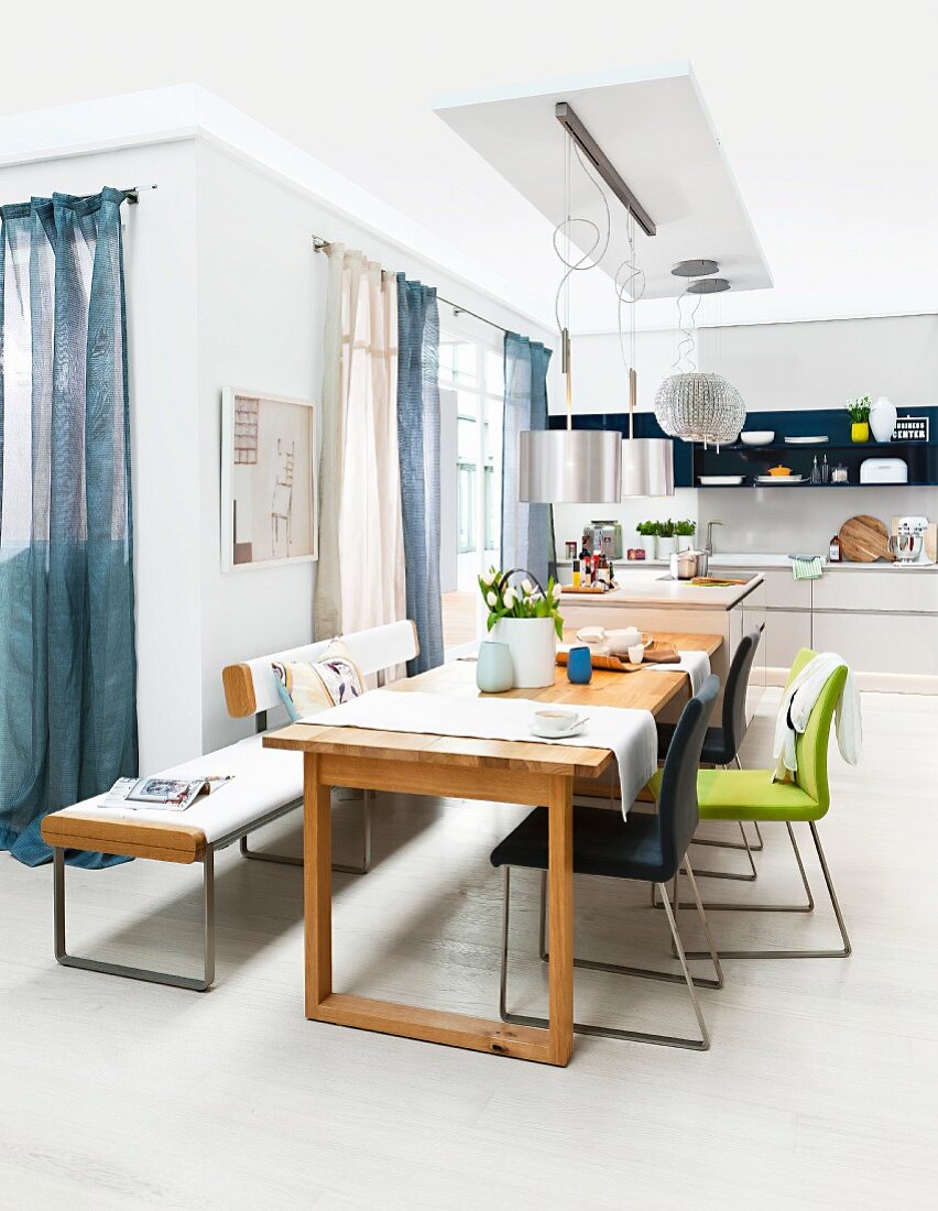 Dining room with wooden table and chairs and bench with leather upholstery