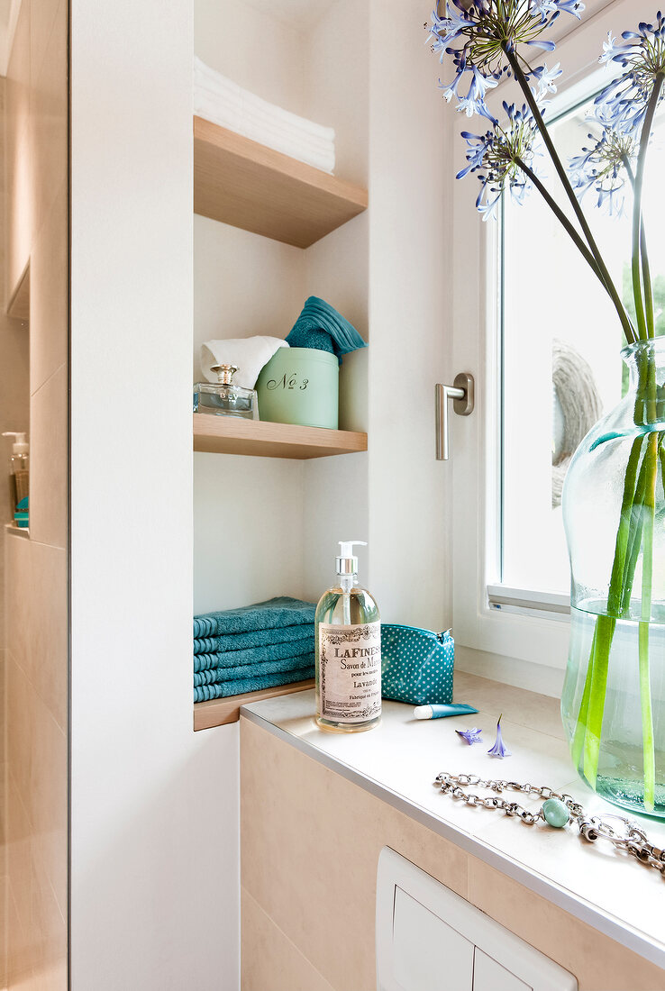 Wooden shelves with vase and accessories in bathroom