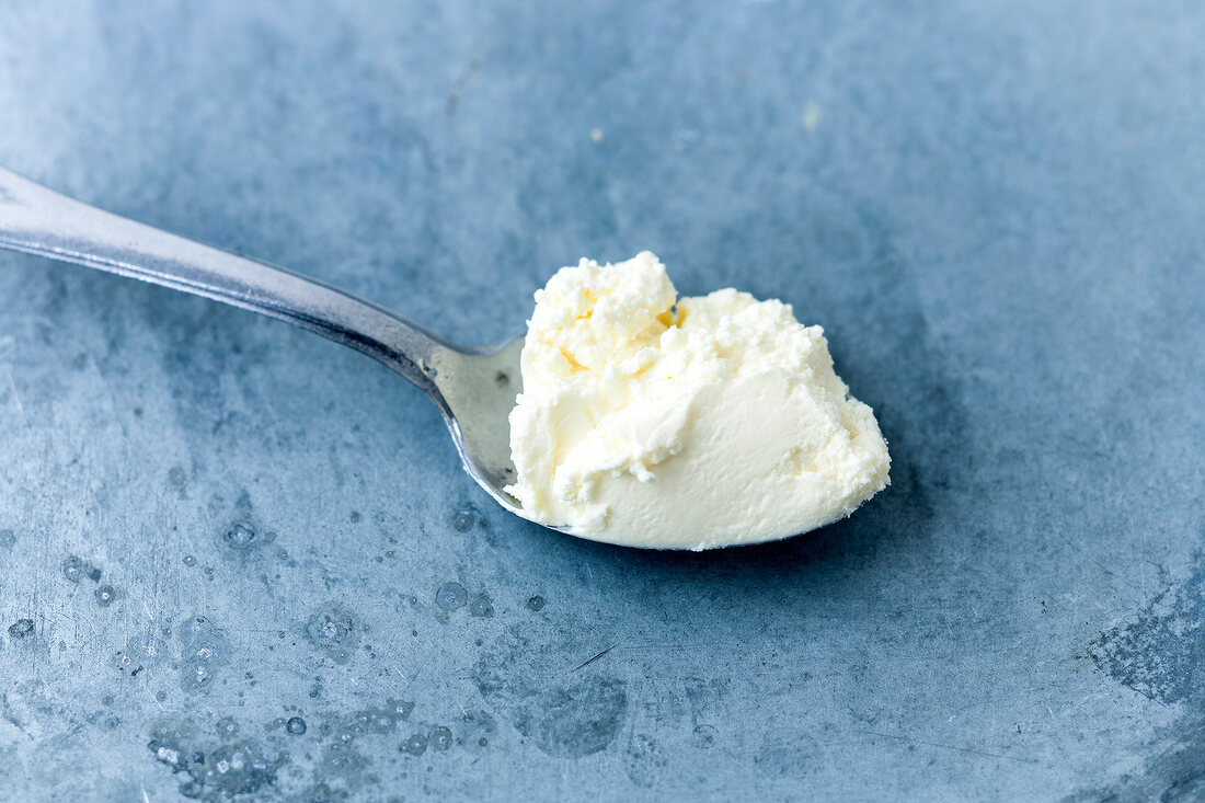 Close-up of cream cheese on spoon