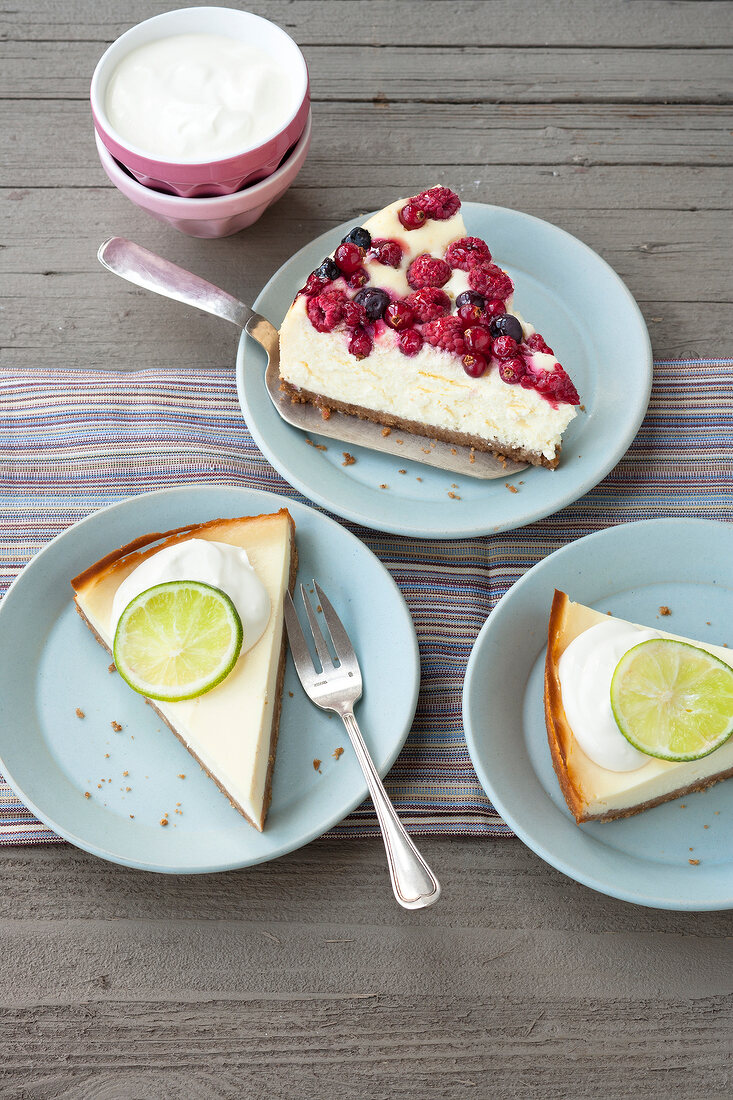 Piece of berry cheesecake and lime cheesecake on plate 
