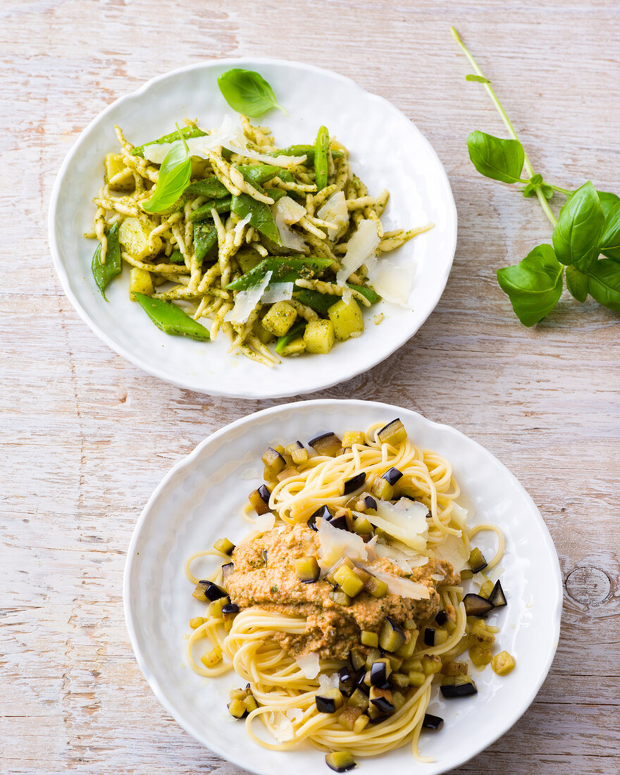 Pasta with almond pesto and pasta with genovese on plates