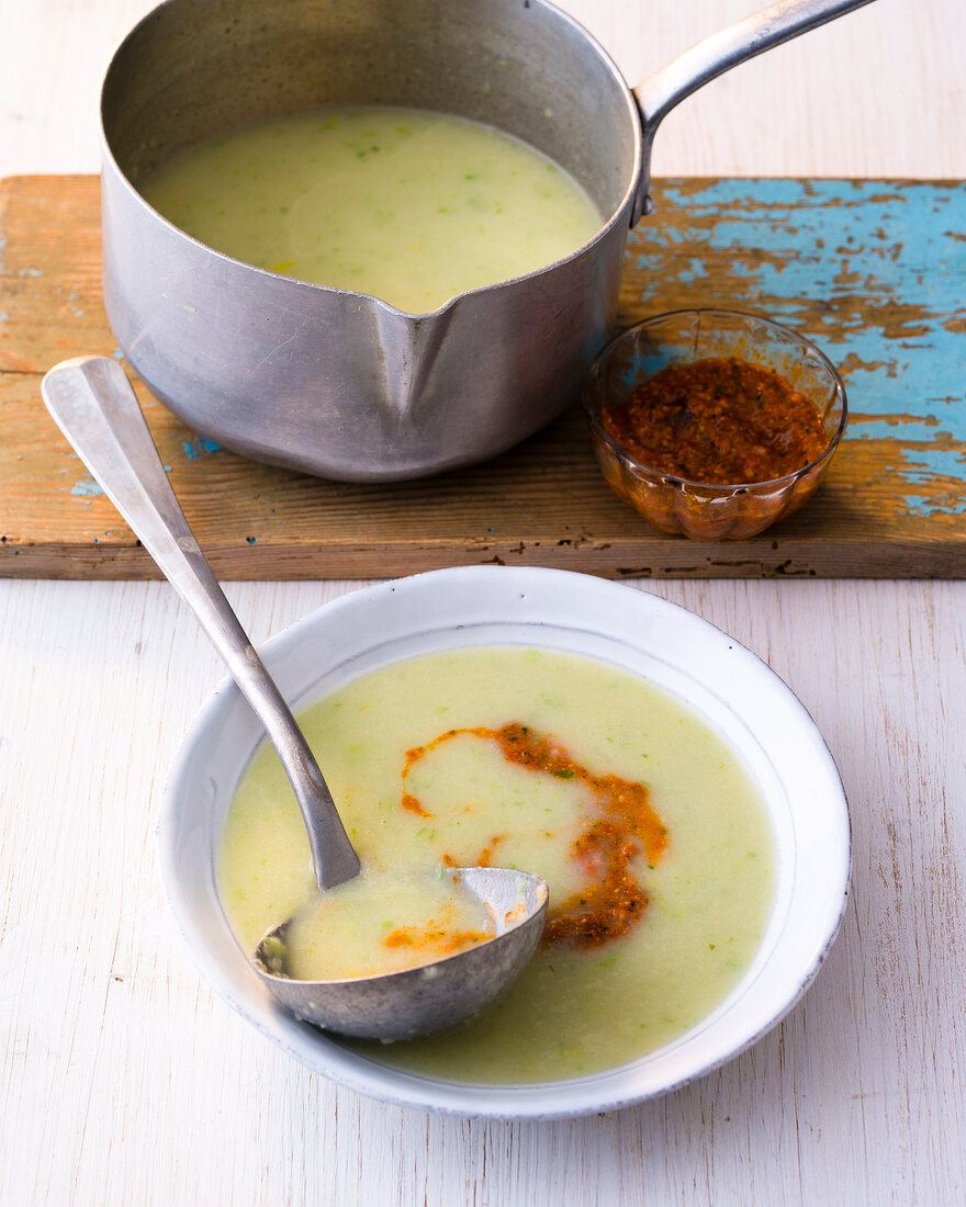Fennel soup with peppers pesto in pot and bowl
