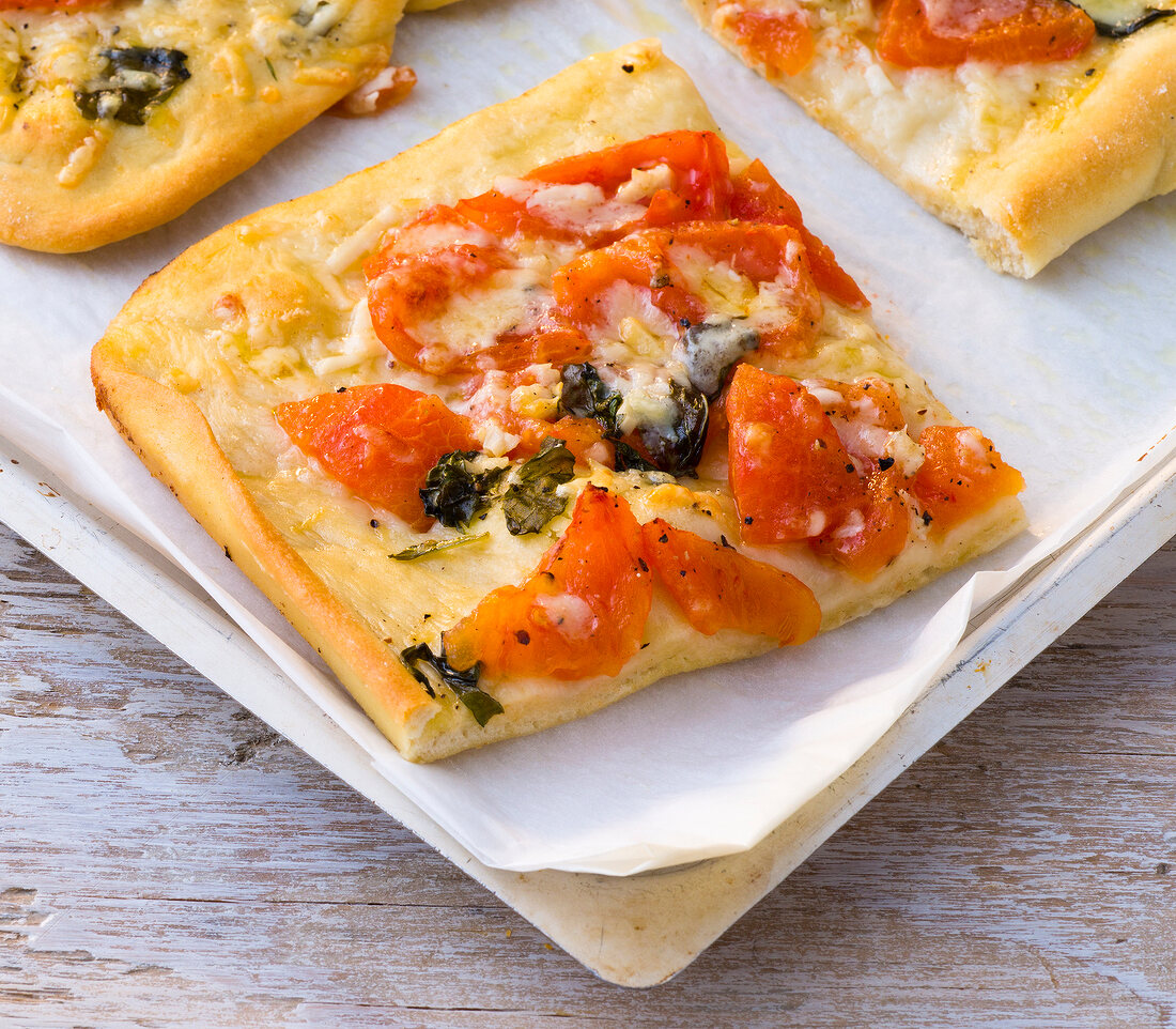 Close-up of tomato and basil pizza on tray