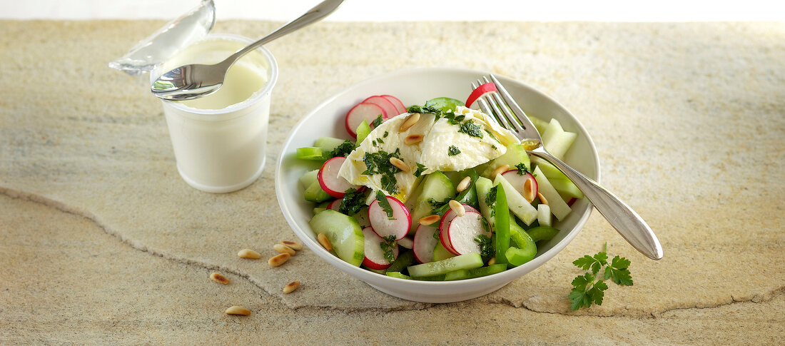 Vegetable salad with parsley dressing in bowl