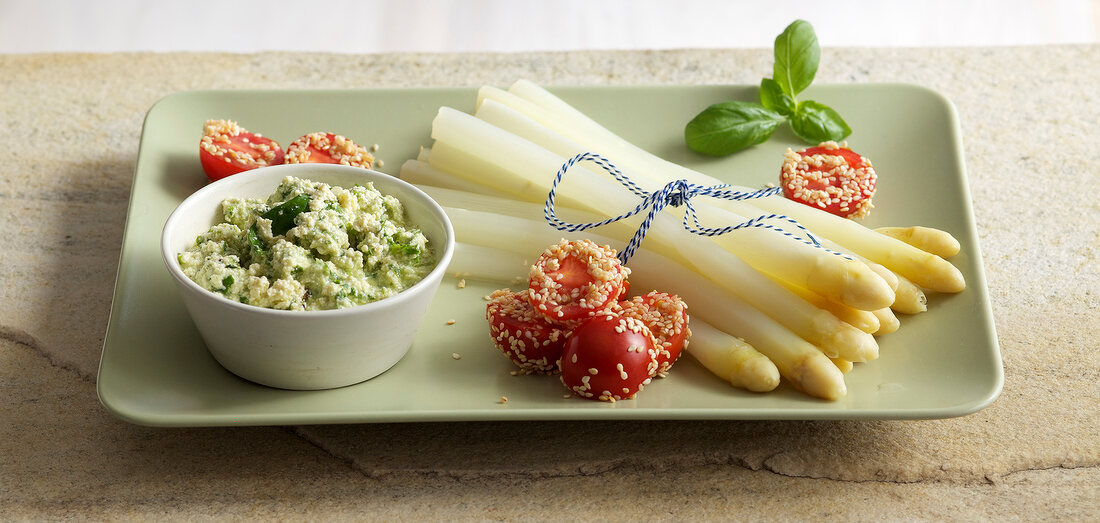 Asparagus with tofu and basil cream in serving dish