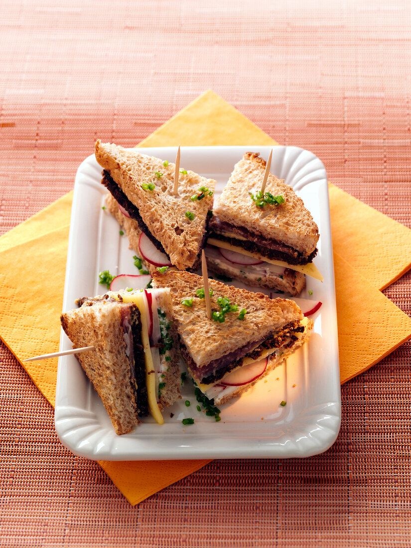 Pumpernickel burgers in serving dish