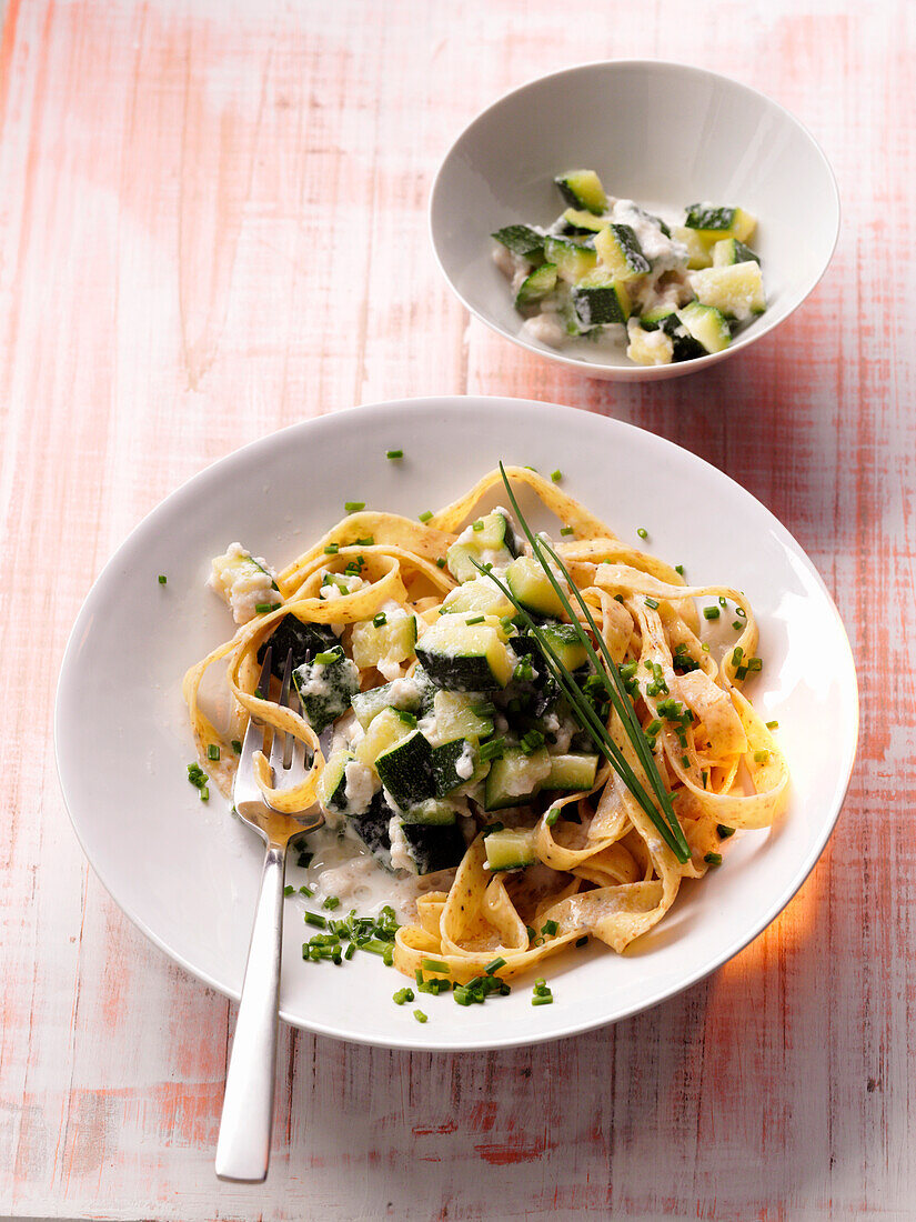 Tagliatelle pasta with zucchini and smoked trout on plate