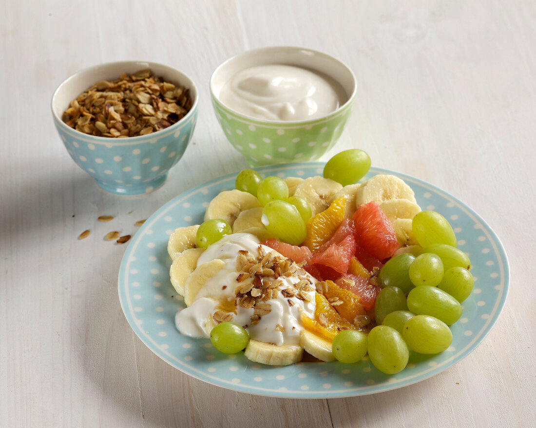 Colourful fruit salad with honey flakes on plate