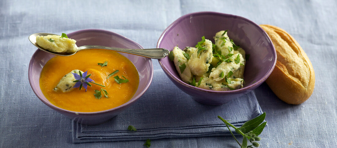 Carrot soup with herb dumplings in bowls 