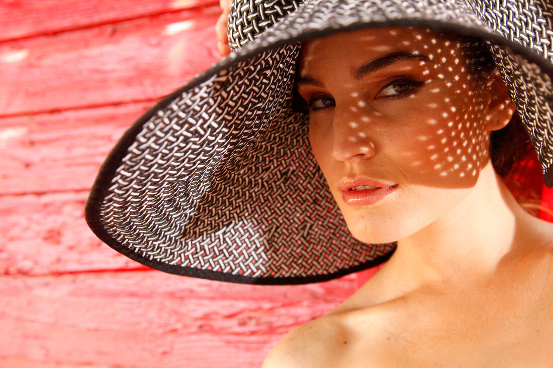 Woman in a sun hat looking thoughtful
