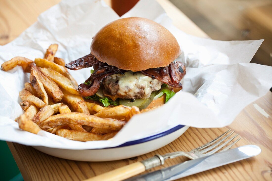 A burger with bacon and chips