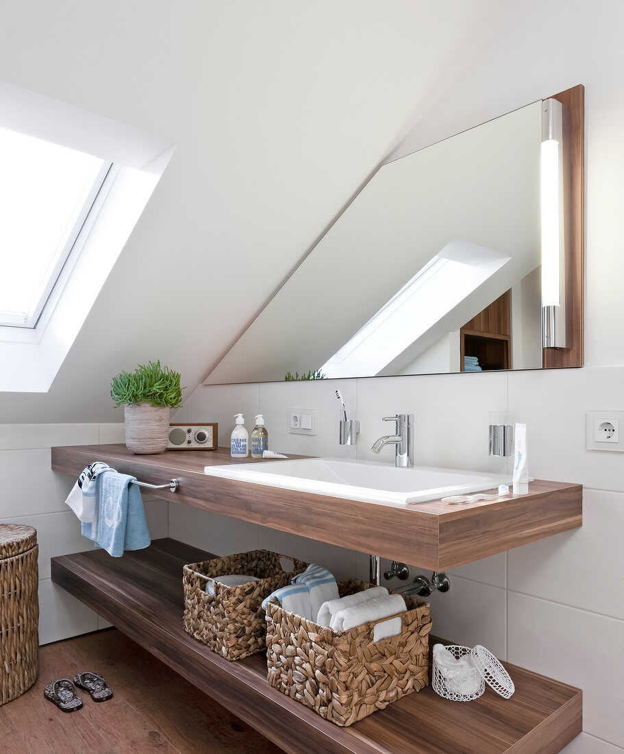 Interior of bathroom with vanity sink with mirror and container