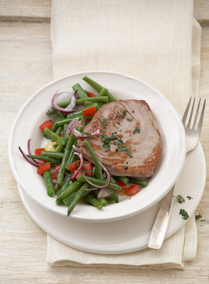 Bean salad with tuna steaks on plate
