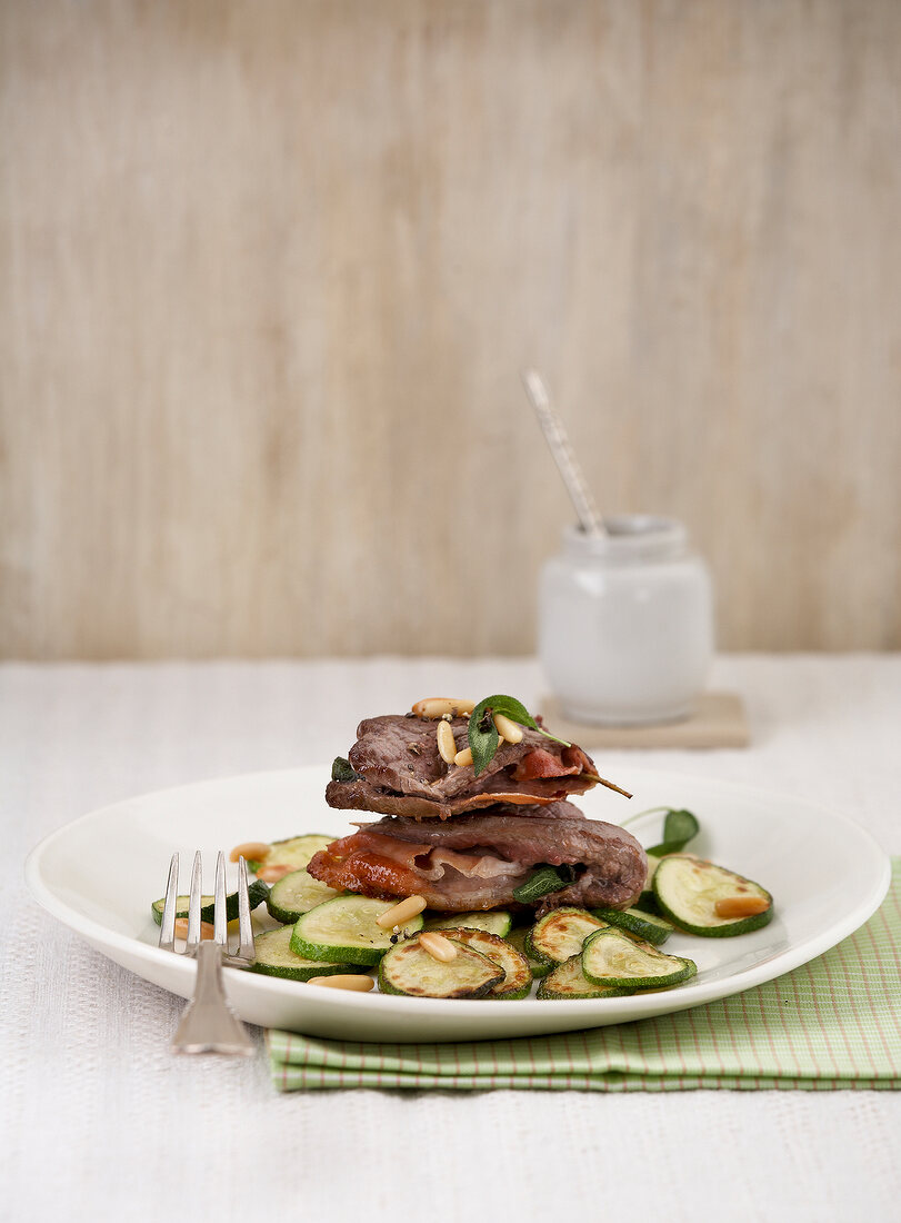Beef saltimbocca with zucchini on plate