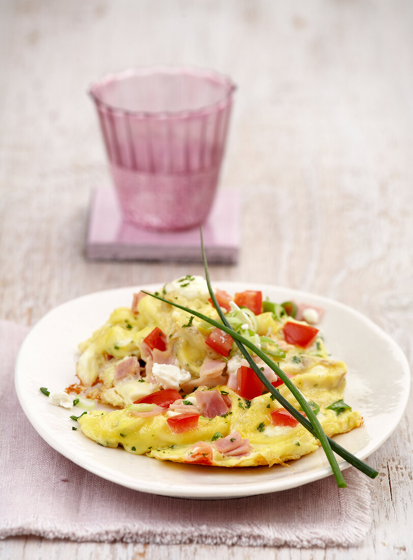 Herb scrambled eggs with ham and cheese on plate
