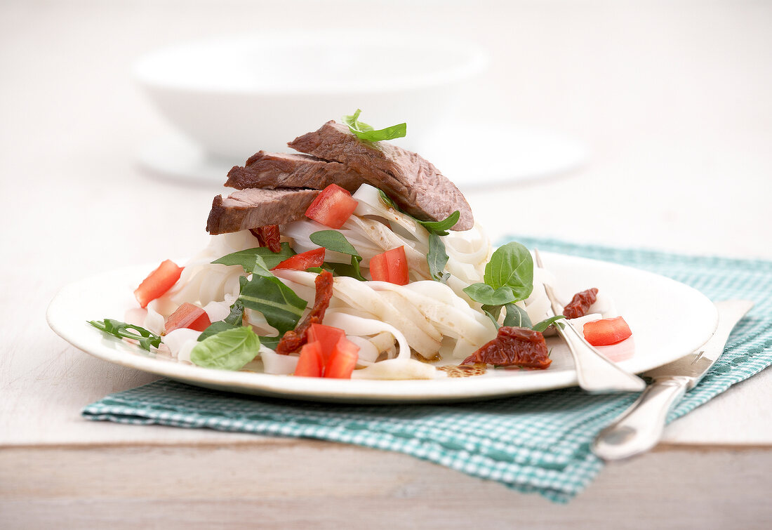 Lamb fillet with noodle salad on plate