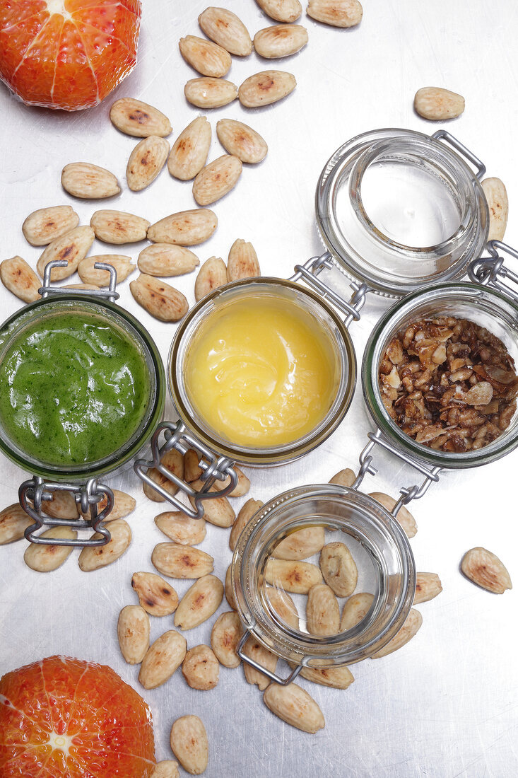 Citrus sauces in bowls with roasted almonds