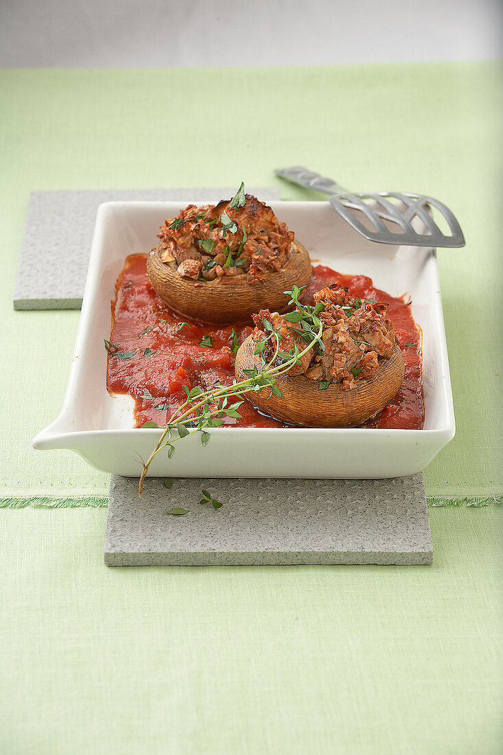Stuffed mushrooms with tomato sauce on serving dish