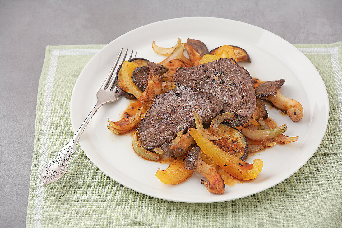 Roasted beef with vegetables on plate