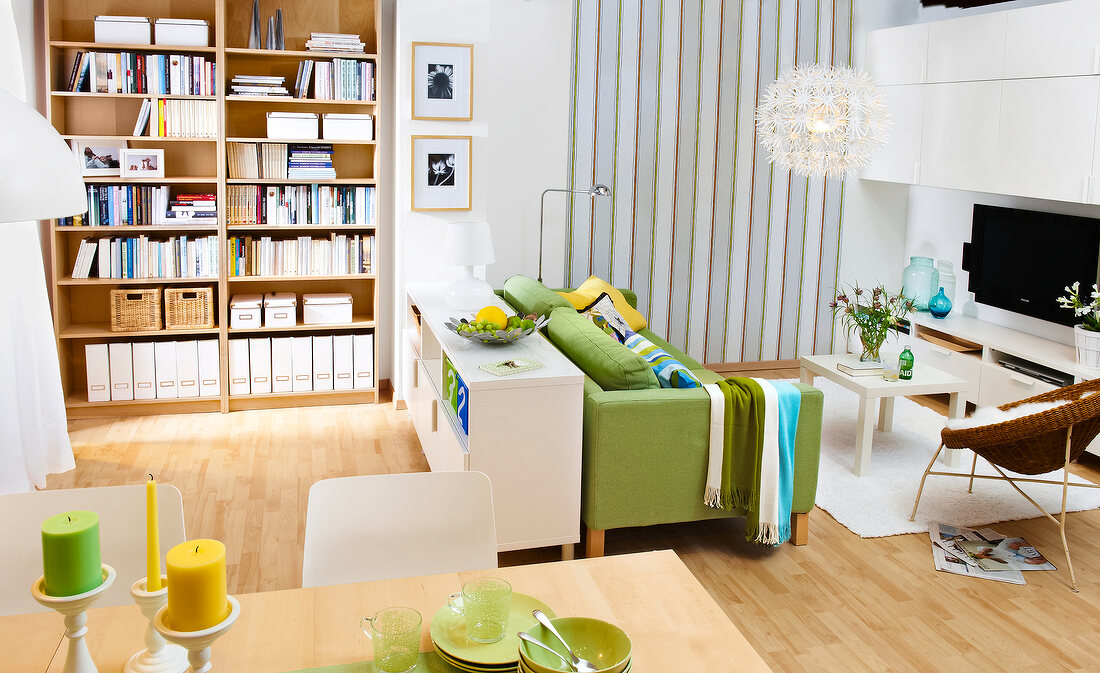 Living room with sideboard, bookcase and green sofa