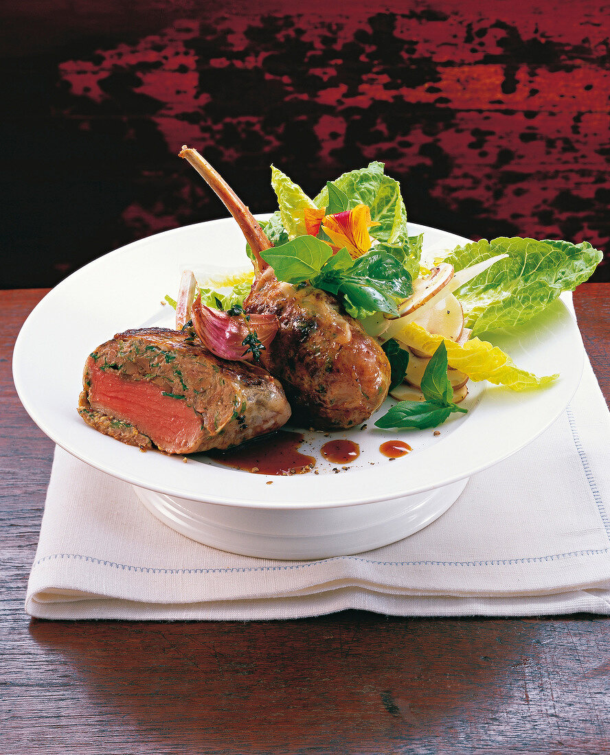 Lamb crepinettes with salad on plate
