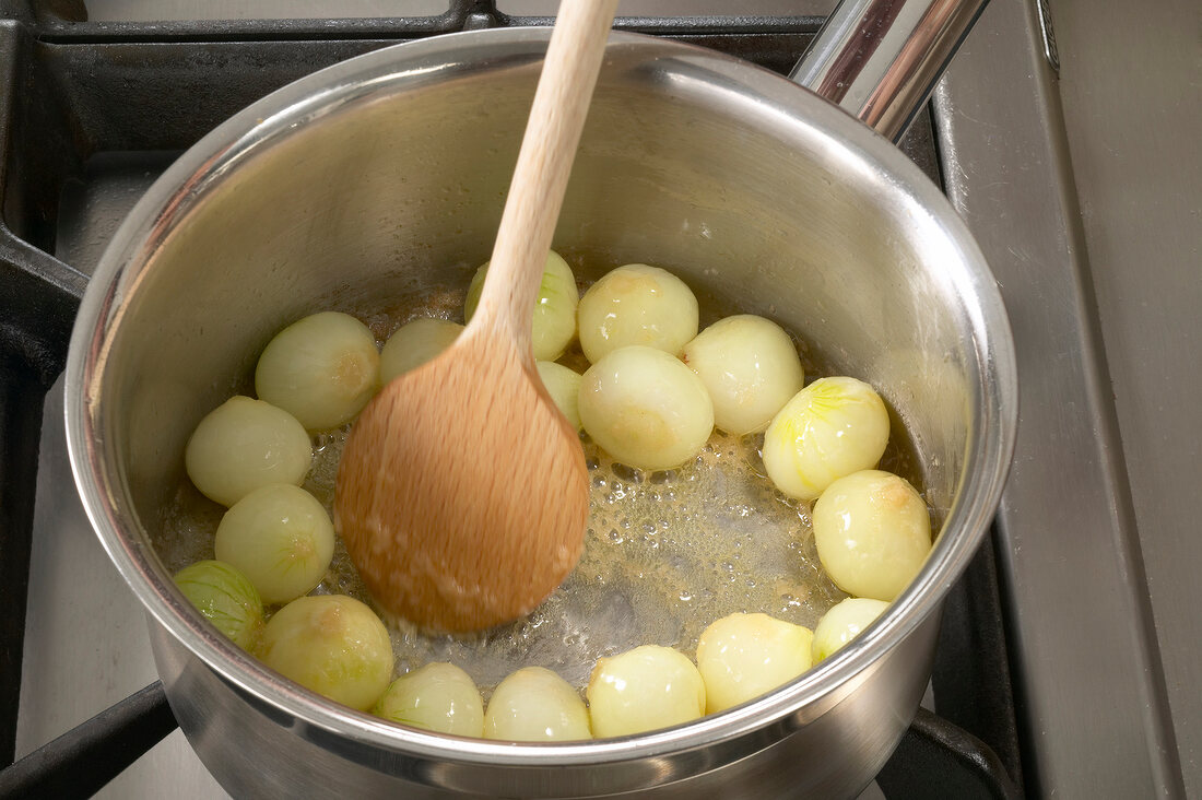 Blanched onions being cooked in melted butter and sugar, step 2