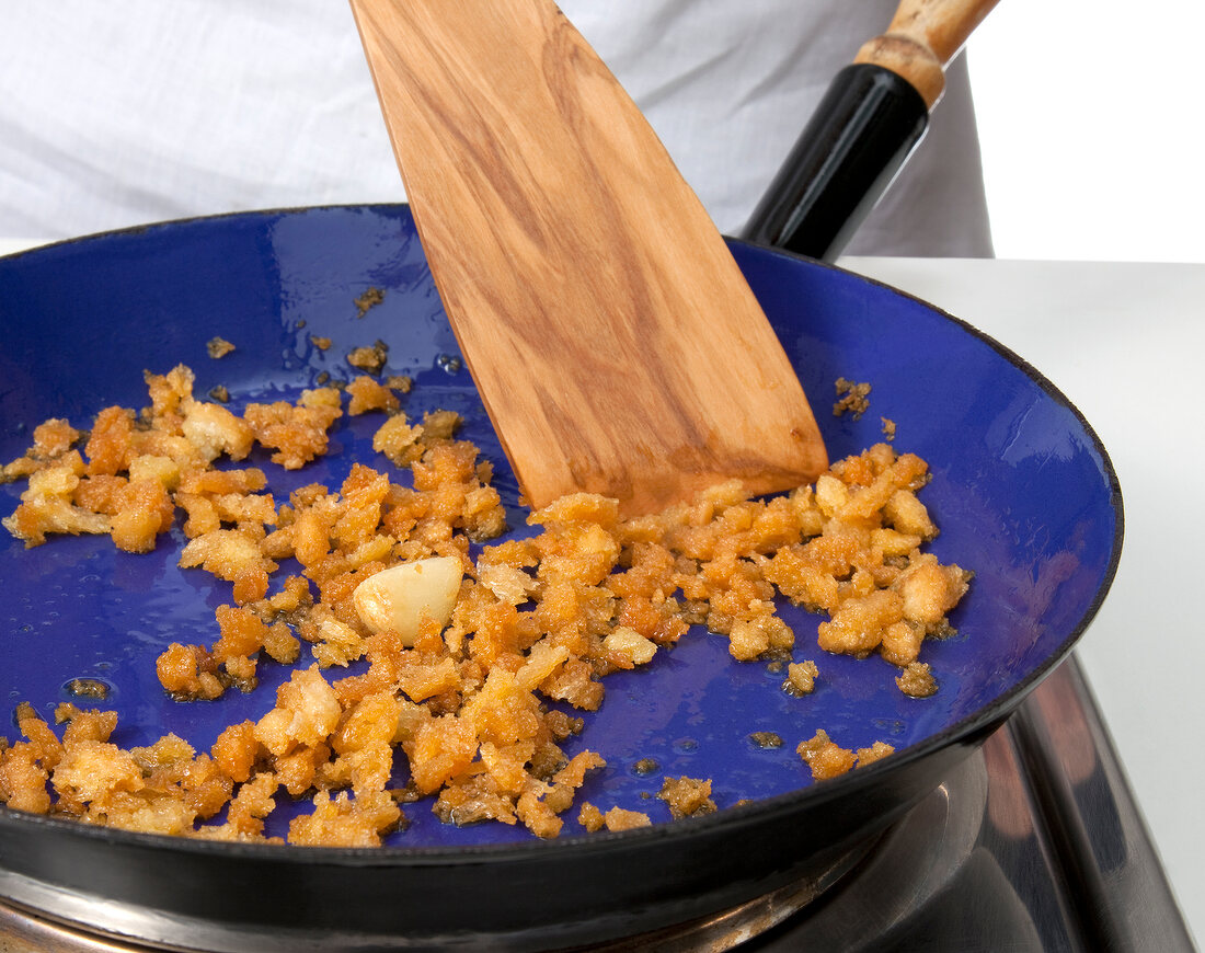 Bread crumbs and parmesan being sauteed in pan