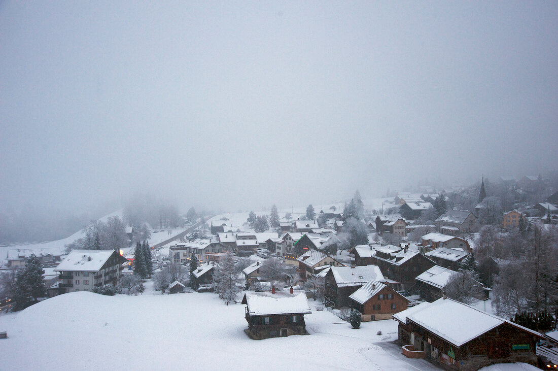 View of snow covered village at Chateau d'Oex, Riviera-Pays-d'Enhaut, Switzerland 