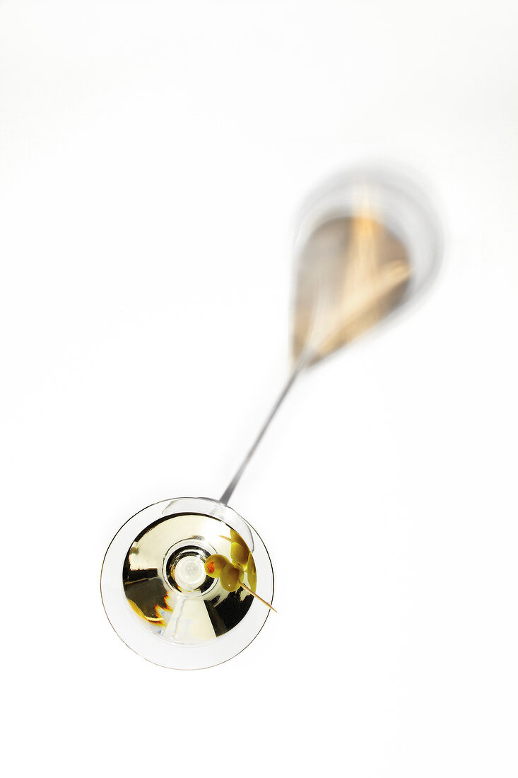 Close-up of martini glass on white background, overhead view