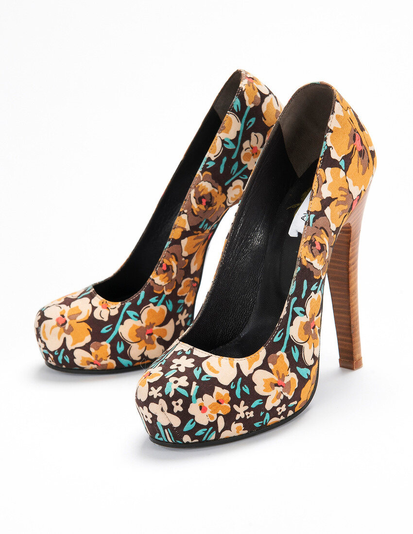 Floral patterned pumps on white background