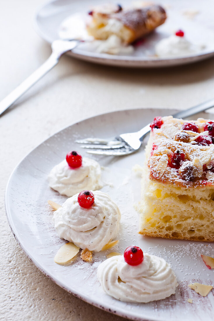 Close-up of baked currant pastries and meringues on plate