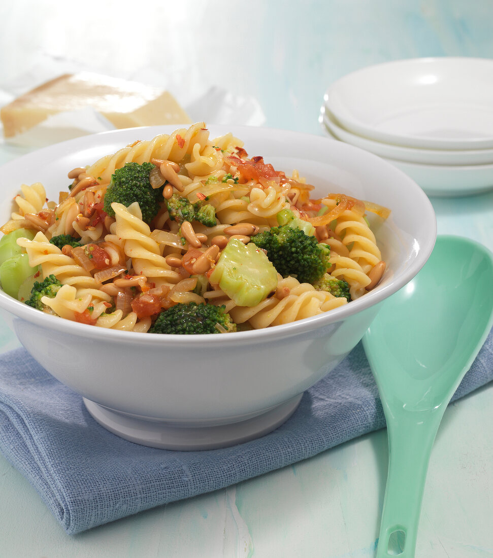 Broccoli pasta with tomato and chilli onions in bowl