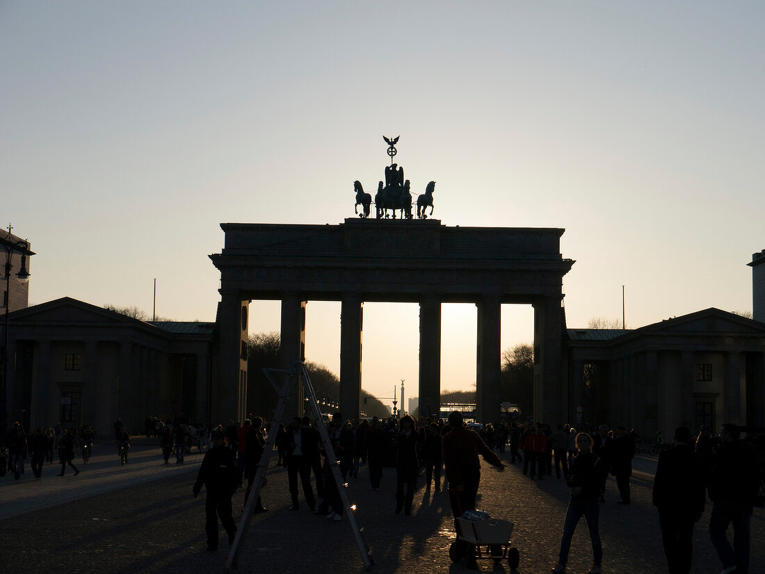 Front view of Brandenburg gate at dusk with people, Mitte, Berlin, Germany