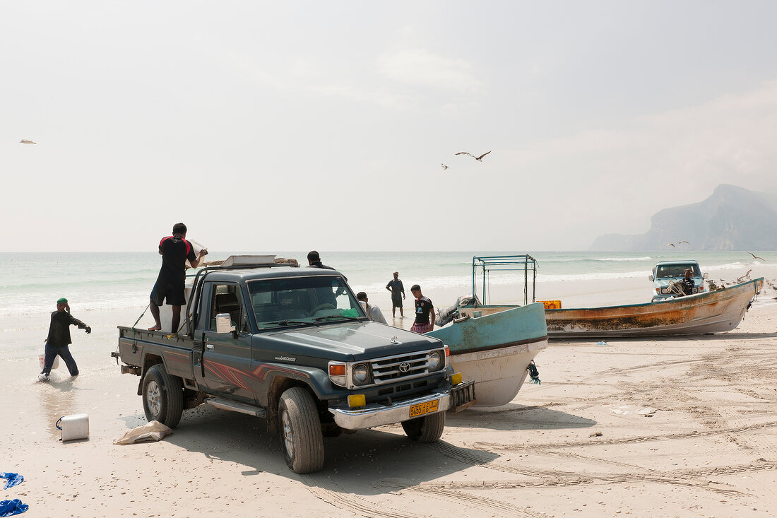 Fishermans catching fish on Maghsail beach, Salalah, Oman