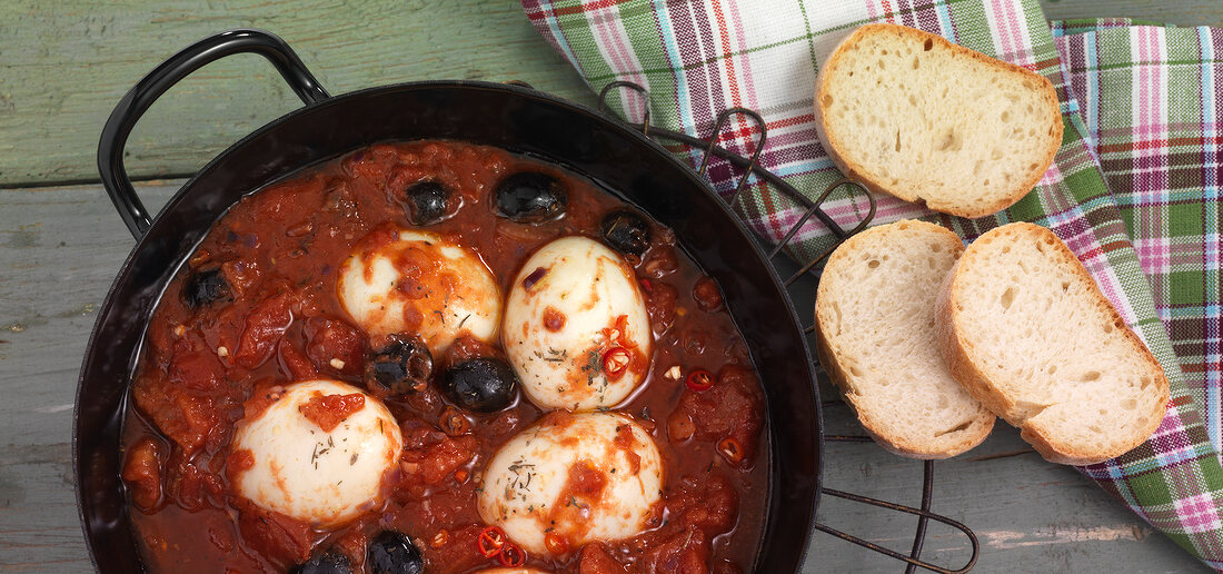 Soft eggs in tomato sauce in serving dish