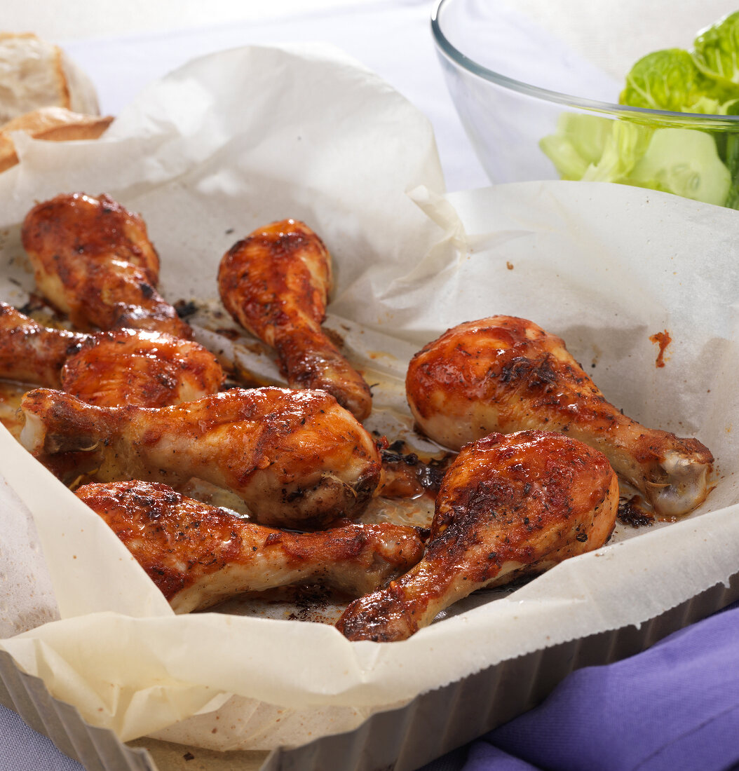 Cooked chicken legs in baking tray