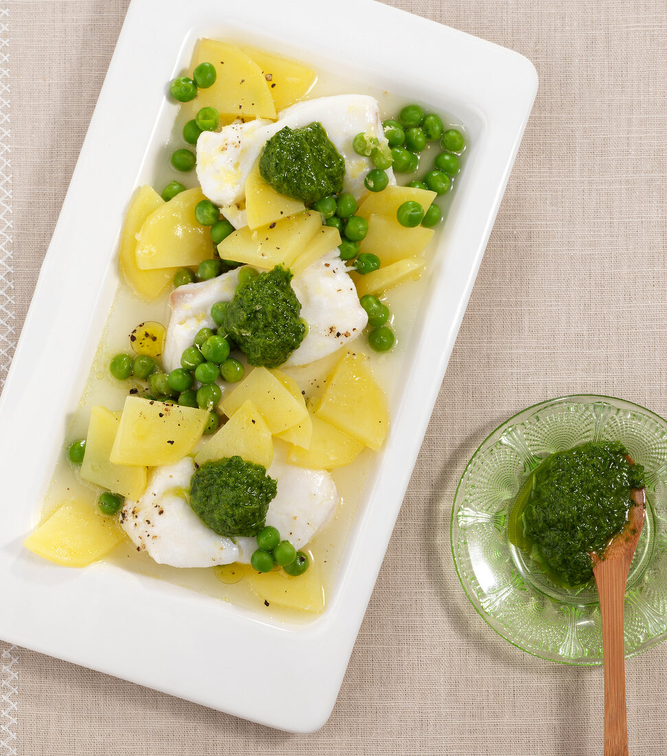 Fish with herb oil in serving dish